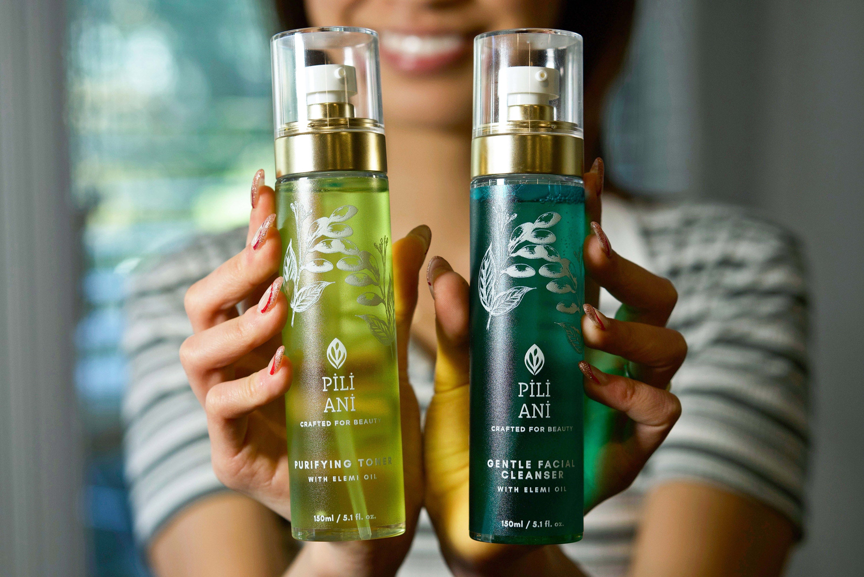 girl holds Pili Ani’s Cleanser and Toner side by side